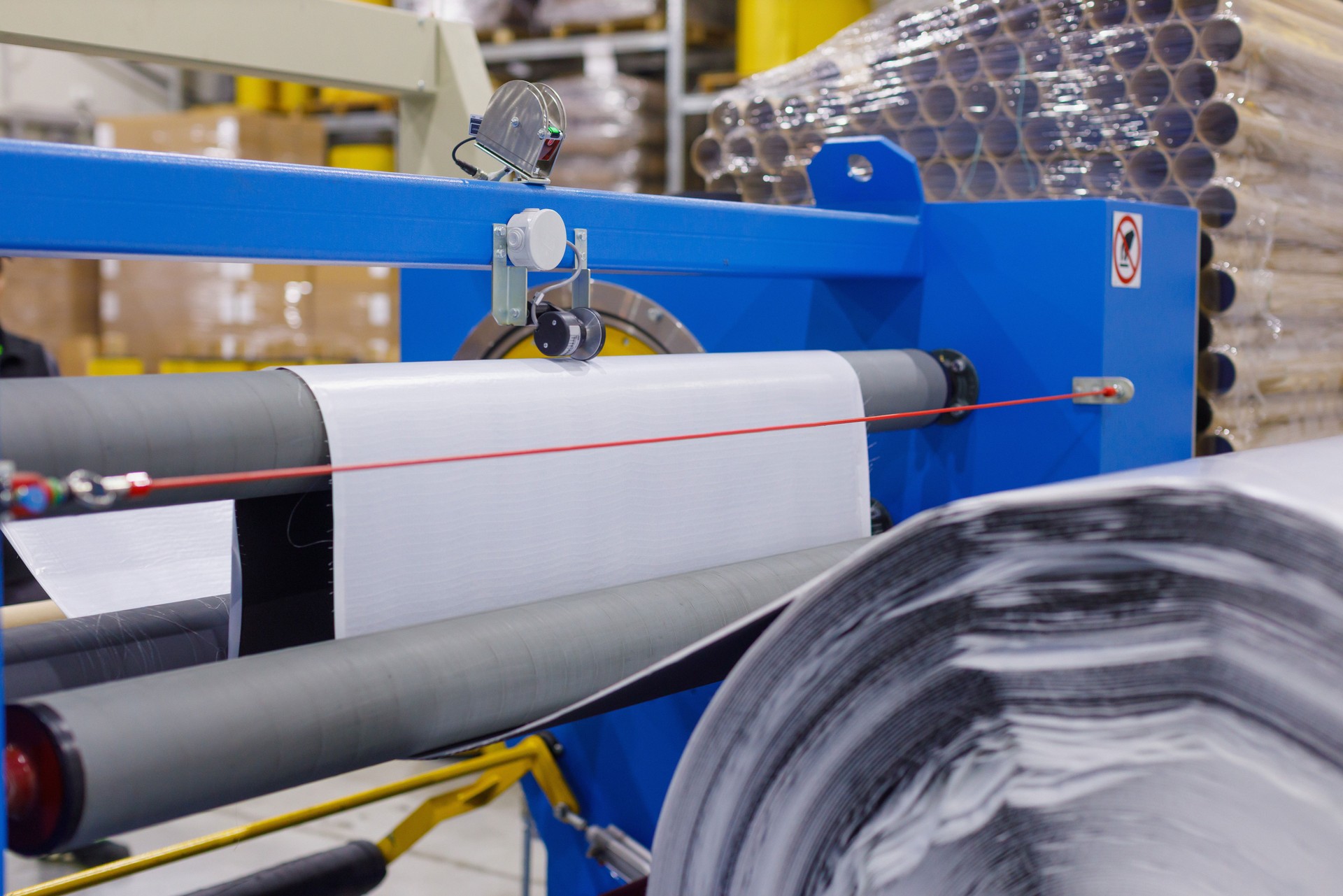 Machine in production line, sheets of electrical insulating tape on the spools